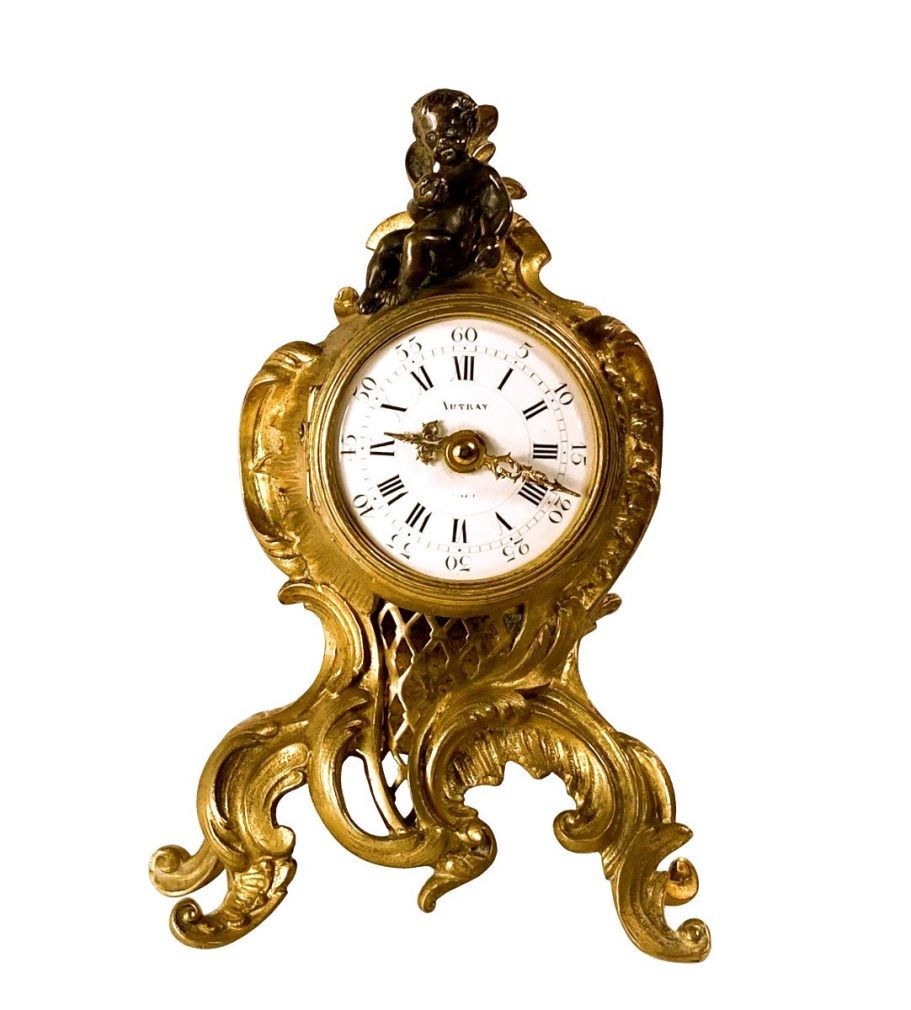 Horloge miniature en bronze doré Horloge miniature en bronze doré signée Autray